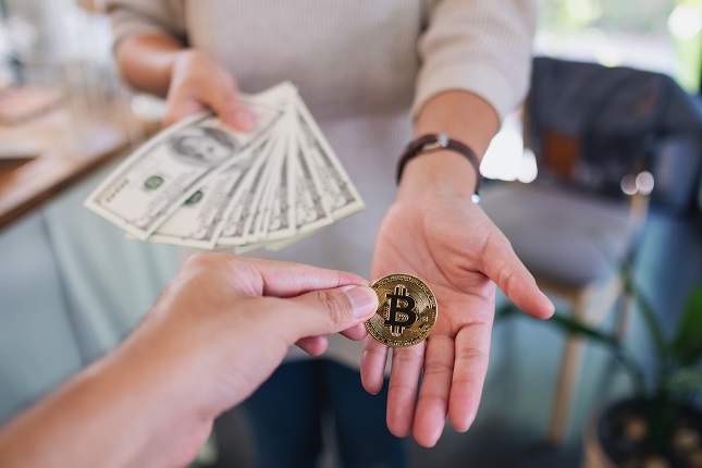 Closeup image of people holding and exchange or convert bitcoins