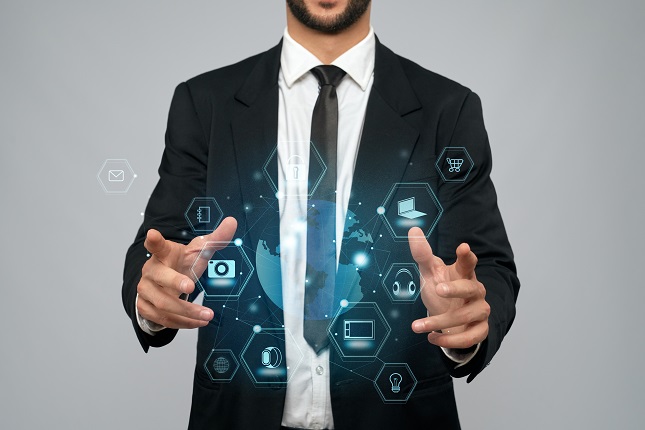 Businessman holding virtual 3D projection in arms.